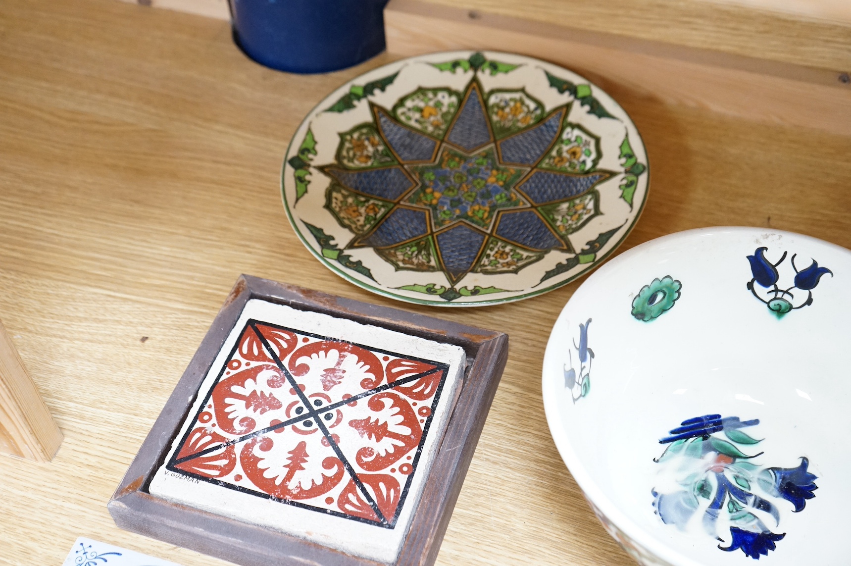 A collection of European tiles, to include a German rampant lion example, dishes and a Belgian bowl, largest 27cm in diameter. Condition - varies